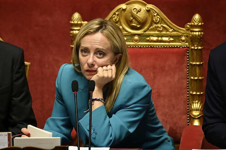 Giorgia Meloni looking downcast in parliament.