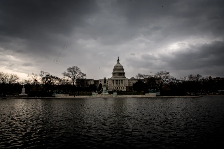 A domed white building under a dark sky.