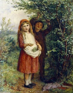 Two children collecting nuts