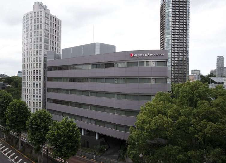 A building with the sign 'Johnny &  Associates.'