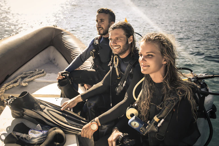 Group of scuba divers going to the dive point with a boat