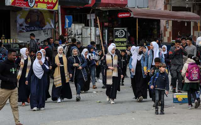 Palerstinian schoolchildren walk in the street in Rafah at the southern end of Gaza.