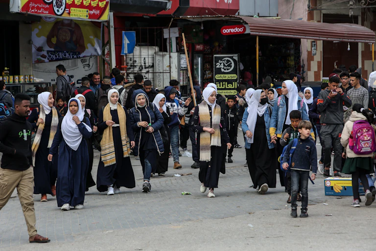 Palerstinian schoolchildren walk in the street in Rafah at the southern end of Gaza.