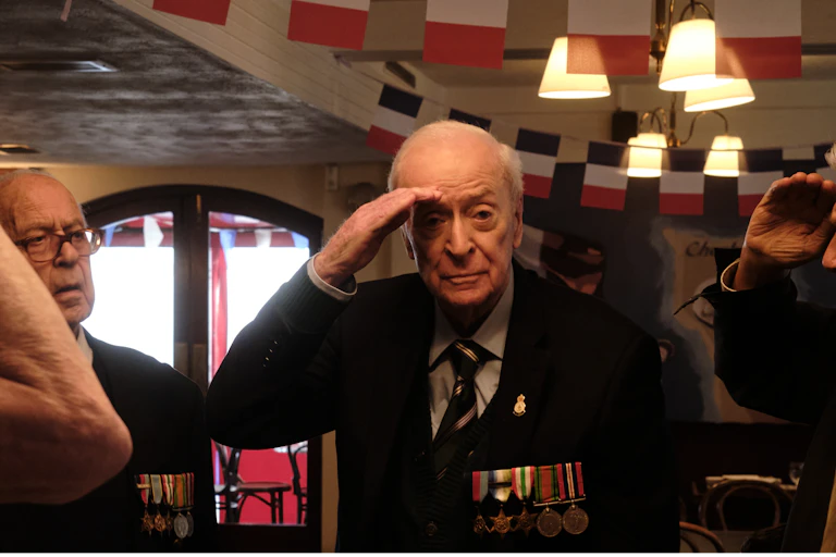 Caine in military medals saluting