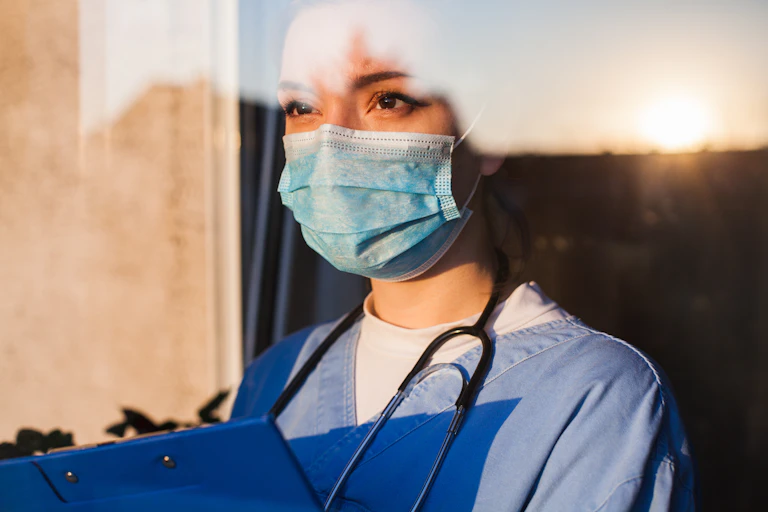 Woman doctor looks out the window