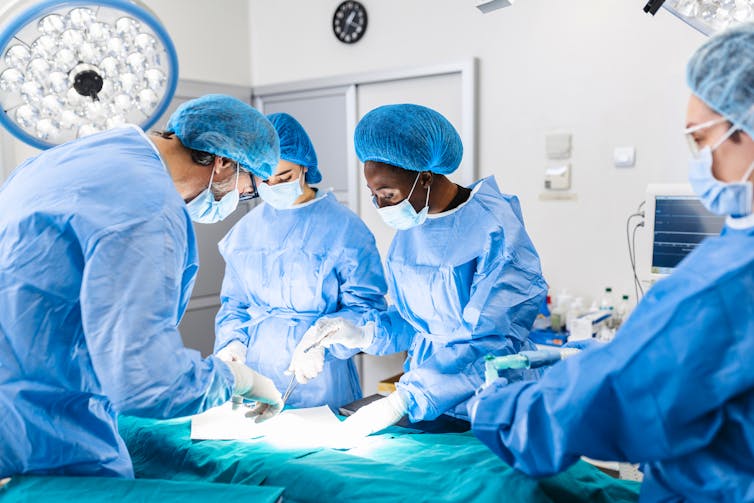 Surgeons work in an operating theatre