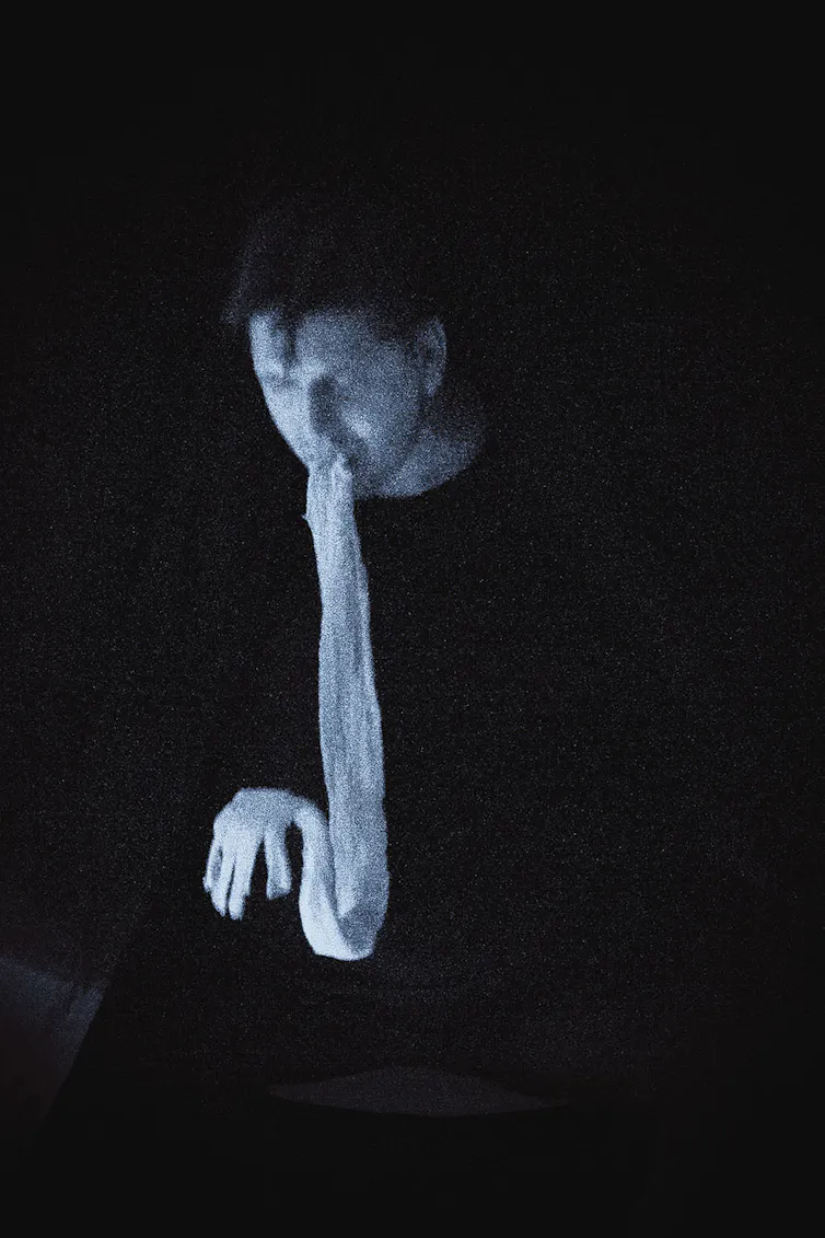 A figure seen with a ghostly translucent substance coming out of the mouth.