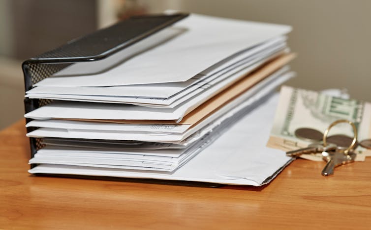 A large pile of unopened letter on a desk top