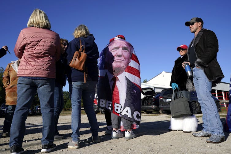 People await the arrival of Donald Trump at a rally in Iowa.