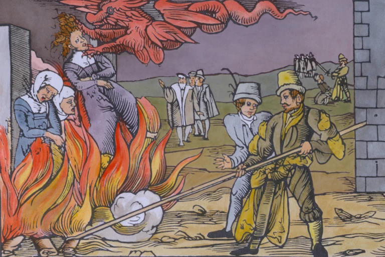 Women being burned at the stake while men stoke the fires.