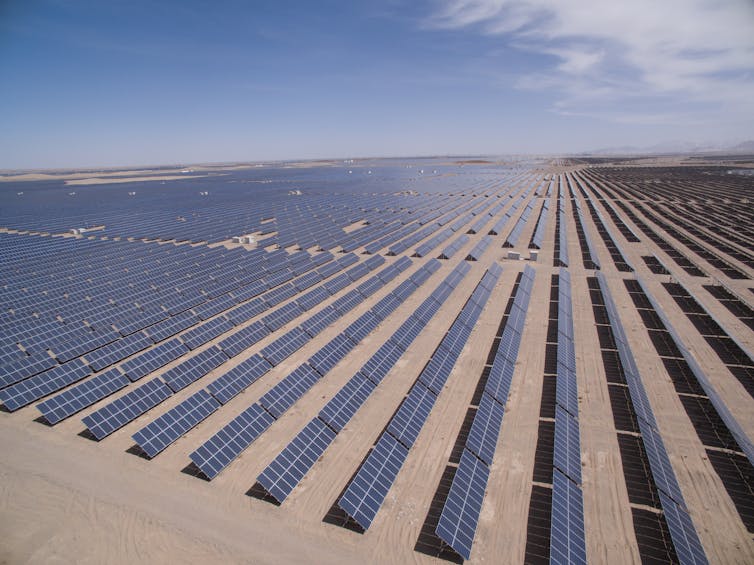 A huge solar power plant stretching towards the horizon.