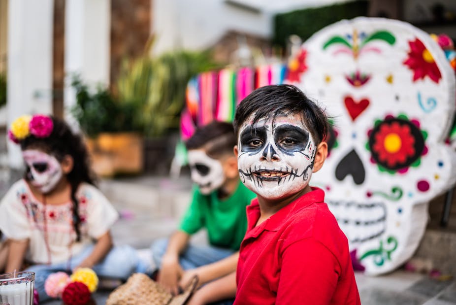 Boy with face paint at a celebration in Mexico.