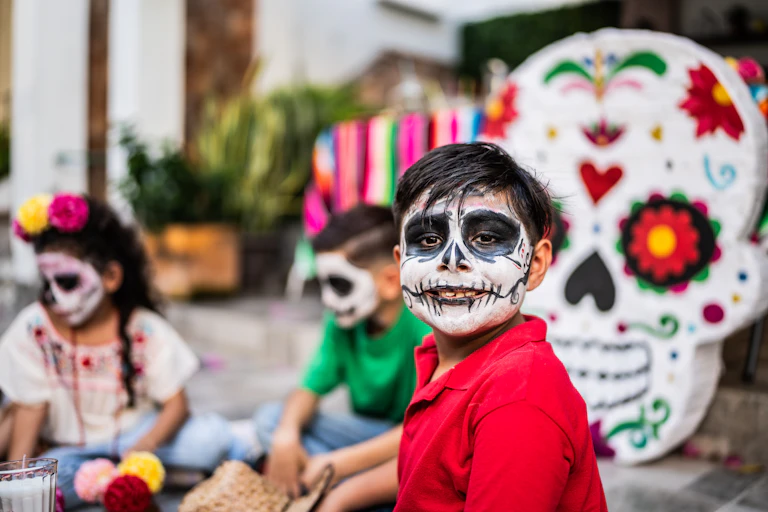 Boy with face paint at a celebration in Mexico.