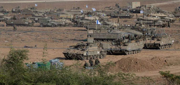 Israeli tanks massed on the border with Gaza in readiness for a possible ground invasion.