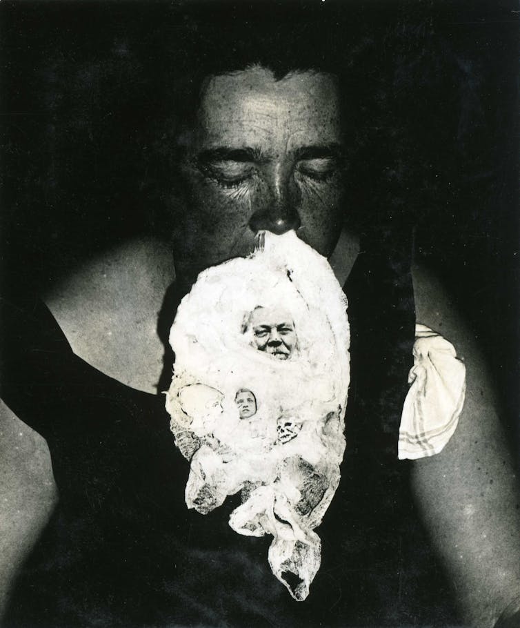 A woman seen with a fluffy substance emerging from her nose and an image of a man is seen in it.