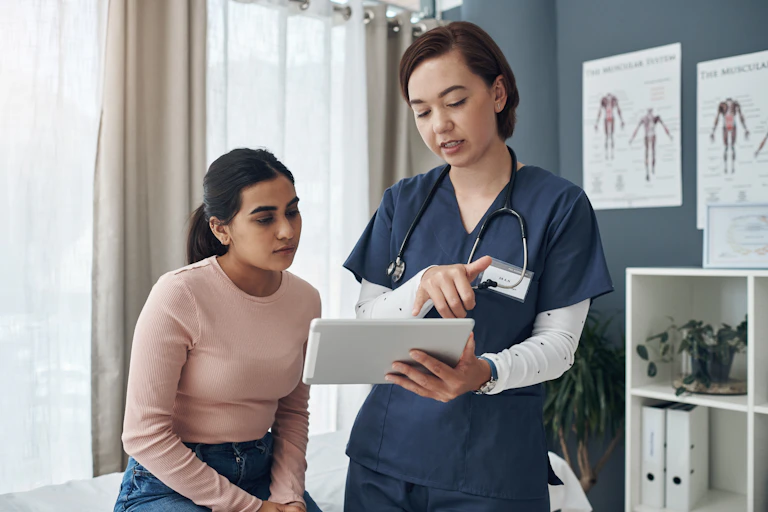Doctor shows patient something on tablet