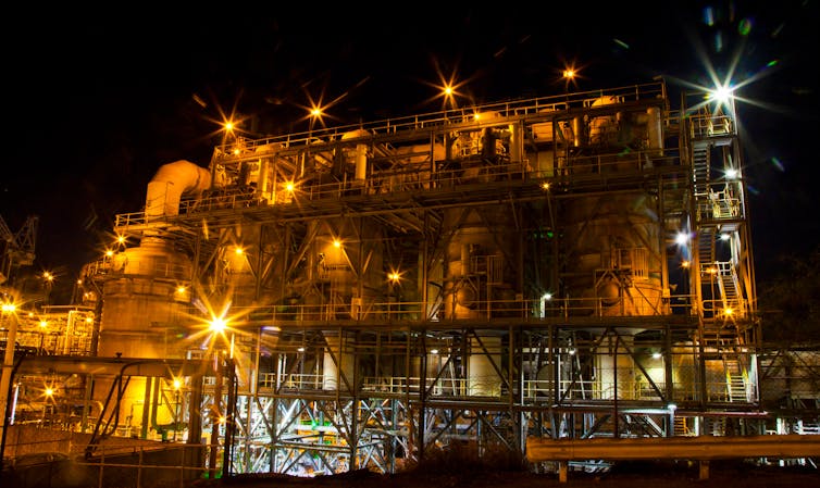 A mine processing plant and smelter lit up at night