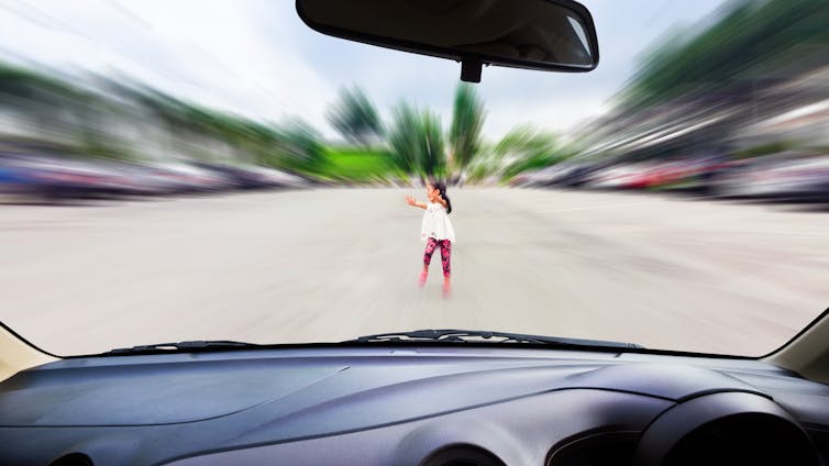 Child on road flings out arms as car approaches – as seen through the windscreen