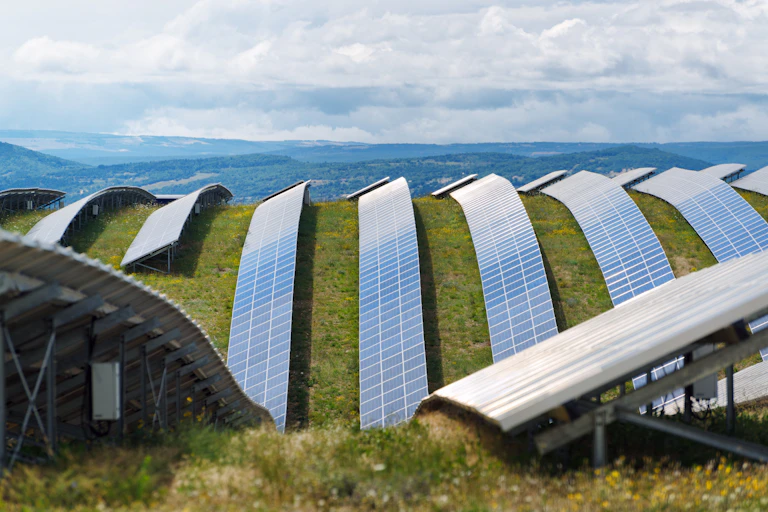 Rows of solar panels in the field on a plateau.