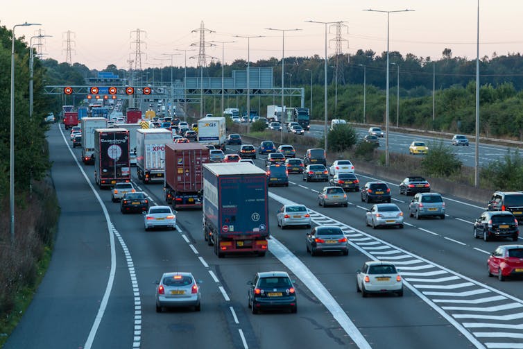 A UK motorway with cars and lorries travelling in one direction.