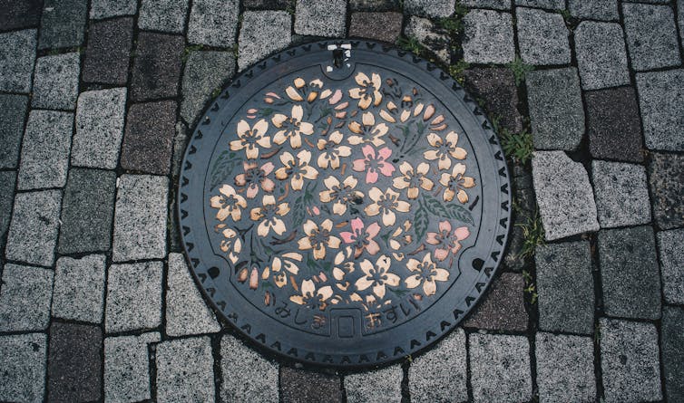 A cherry-blossom themed manhole cover in Japan.