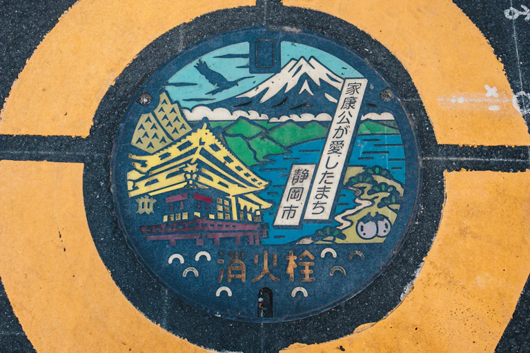 Mount Fuji on colourful manhole cover on a street pavement in Japan.