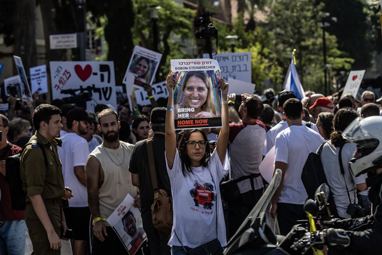 A crowd of people demonstrating and holding signs.