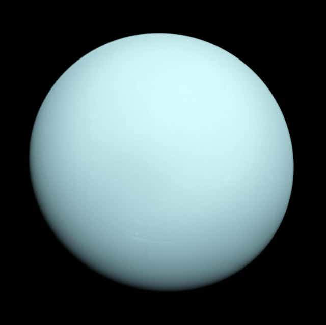 An image of the pale green planet Uranus.