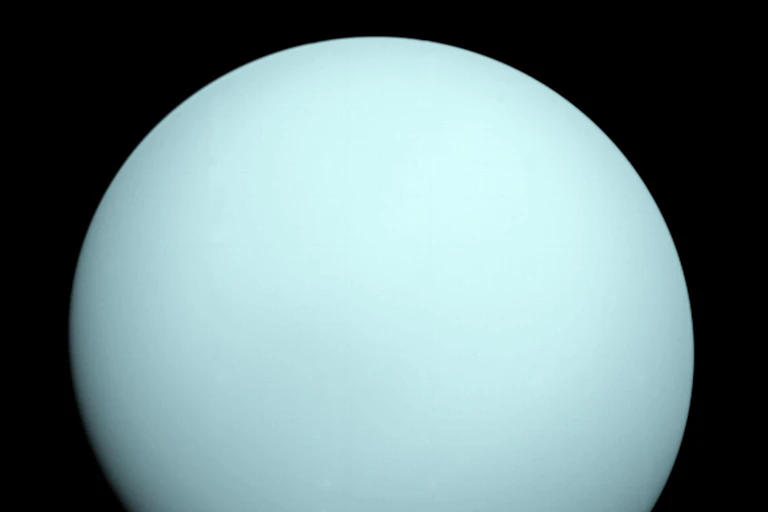 An image of the pale green planet Uranus.