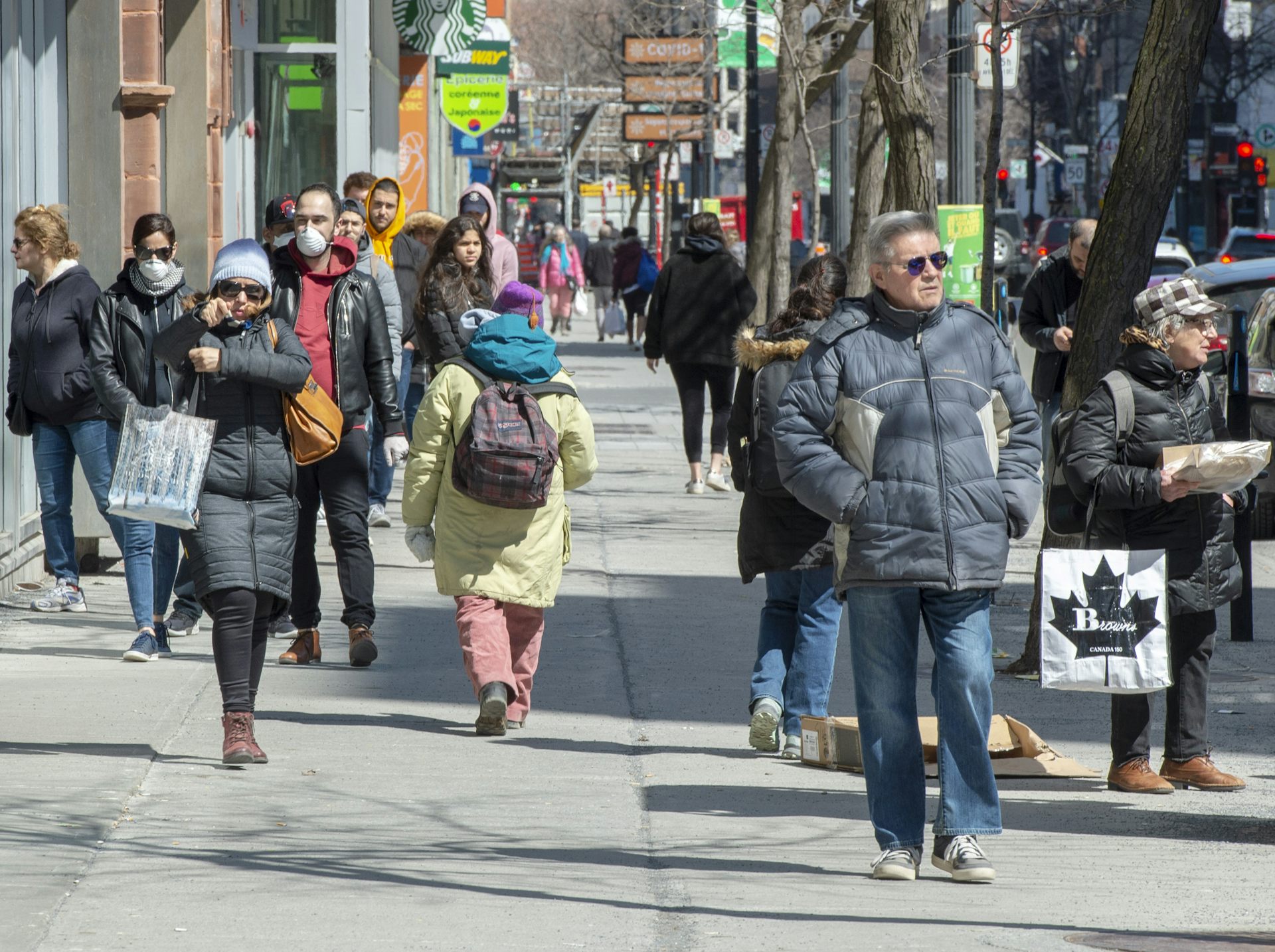 Pedestrians walk down a city street