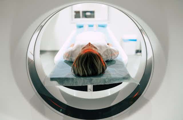 woman lies down for MRI testing