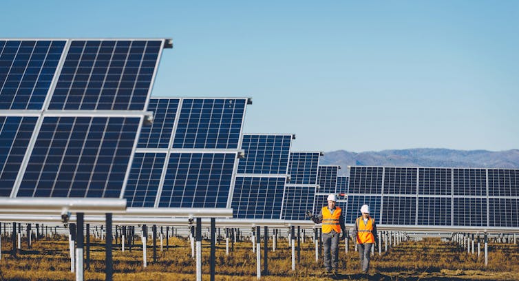 Two workers at a solar farm.
