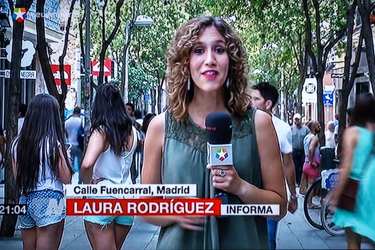 A woman reporter with a microphone.