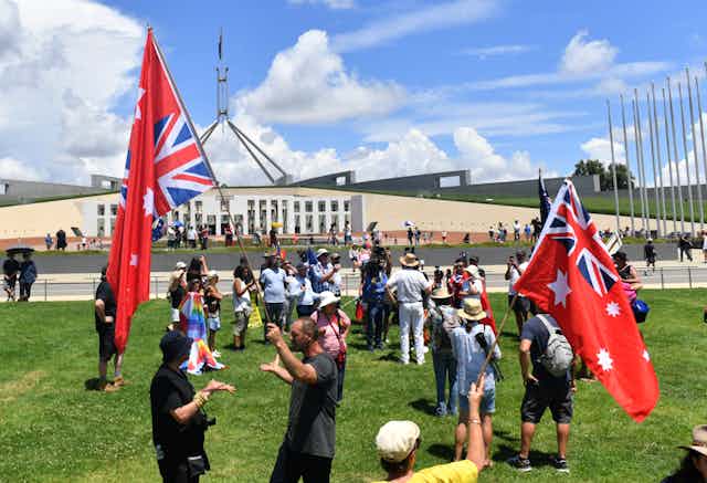 Protestors on Canberra's parliament lawns with the Australian ensign flag