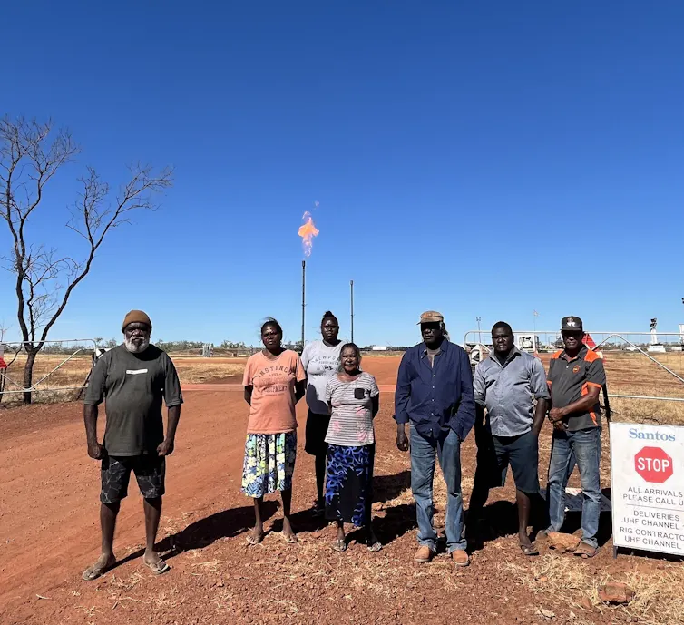 group of First Nations people standing in front of a fracking site in northern territory
