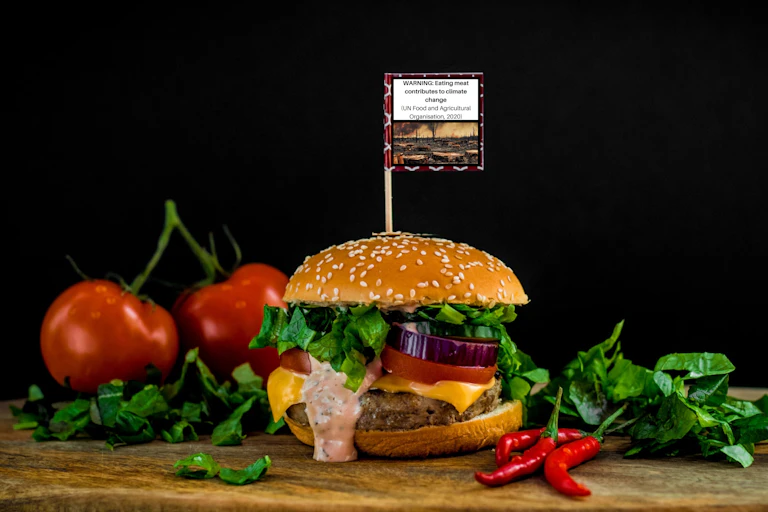 A burger with a small flag attached to a tooth pick.
