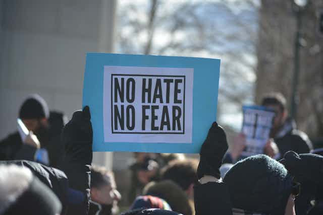 No Hate No Fear sign held by demonstrator.