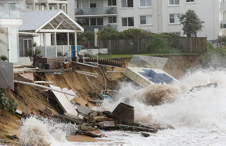 A swimming pool washed away from a home above the beach at Collaroy, New South Wales in June 2016. Photo taken from the beach showing wave action and debris.