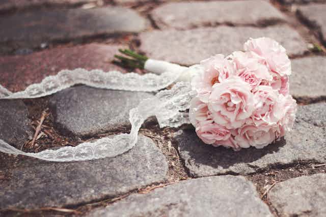 A bridal bouquet on cobblestones