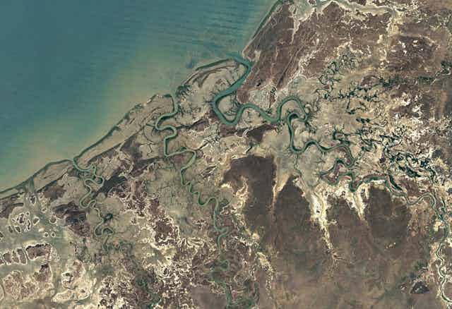 A composite satellite image illustrating how mulitple rivers flow into the Gulf of Carpentaria after a good wet season, brining life to coastal wetlands.