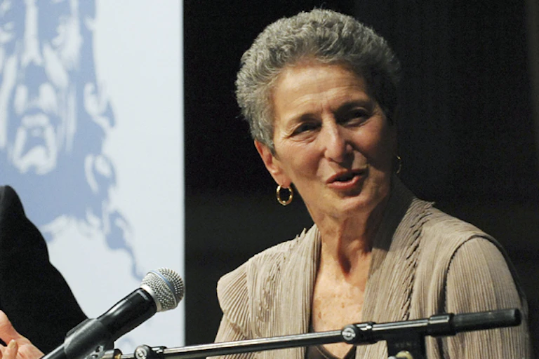 Natalie Zemon Davis speaking at a podium.