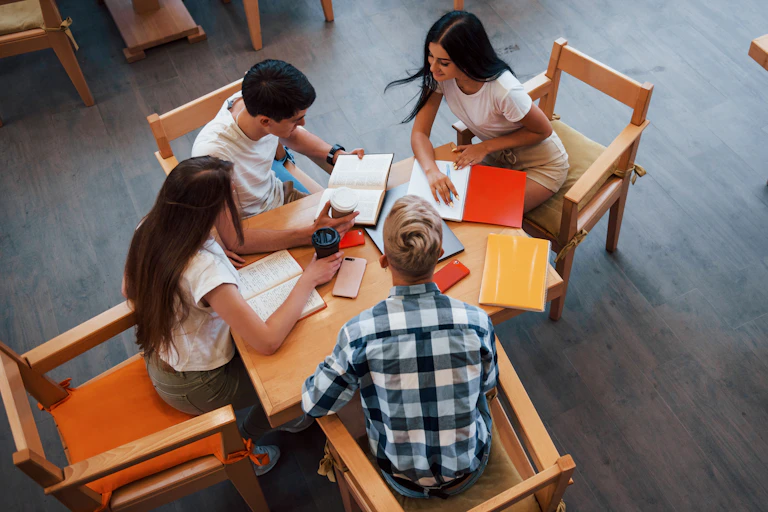 Students seen in a circle discussing.