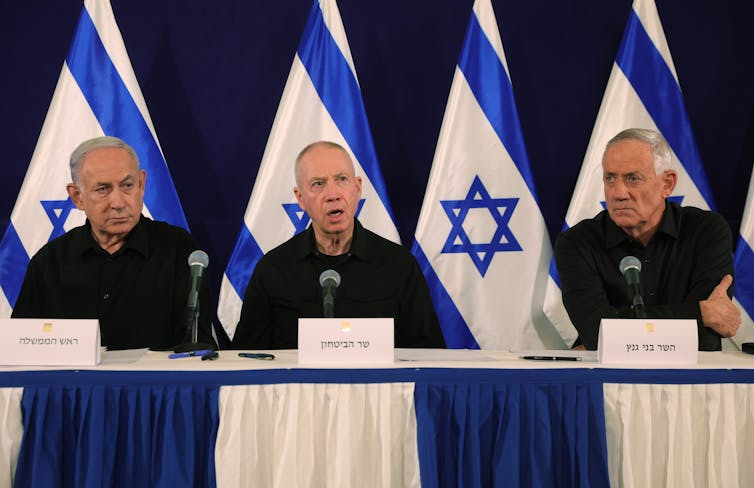 Israel's Prime Minister Benjamin Netanyahu, Defence Minister Yoav Gallant and Cabinet Minister Benny Gantz at a press conference, October 28.