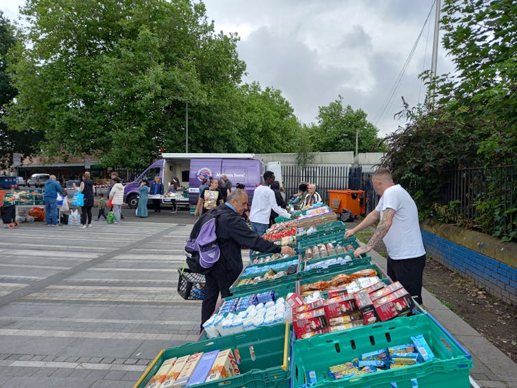 Volunteers hand out food at a mobile pantry for people in need