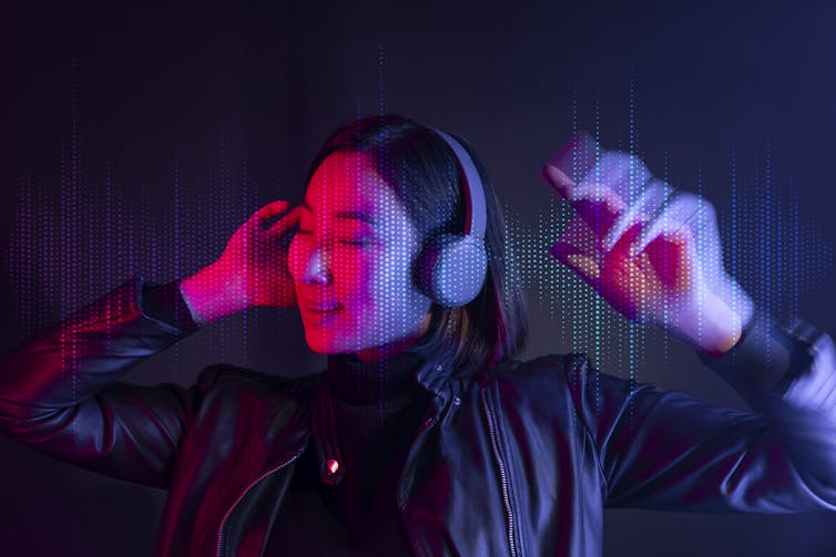 Woman listening to music with wireless headphones.