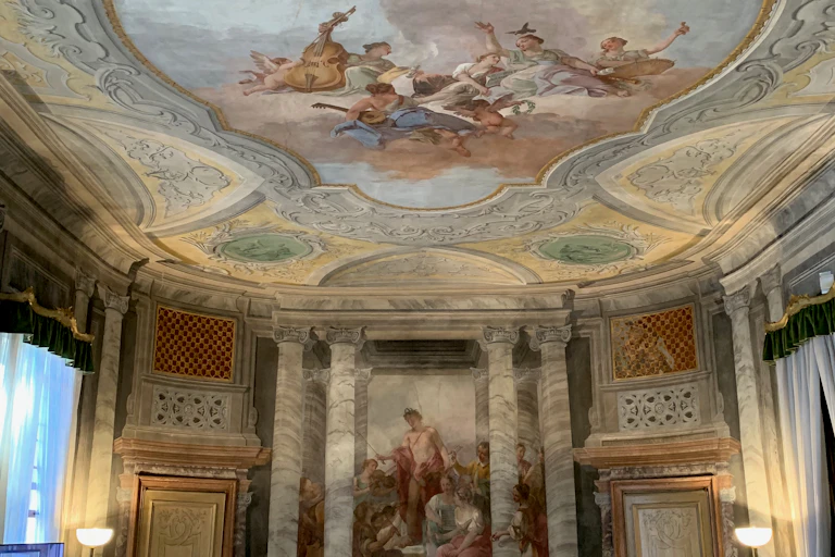 Ornate ceiling depicting angels playing instruments in the clouds.