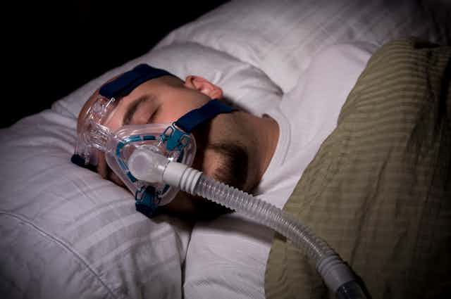 Man sleeping with CPAP mask 