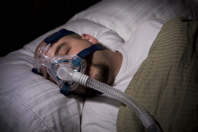 Man sleeping with CPAP mask