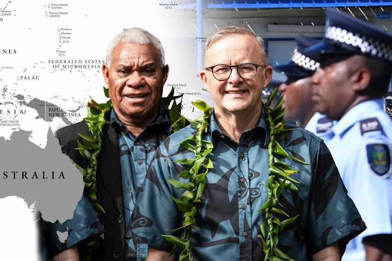 Australian Prime Minister Anthony Albanese with Vanuatu Prime Minister Bob Loughman in front of a map of the Pacific and Fijian police.