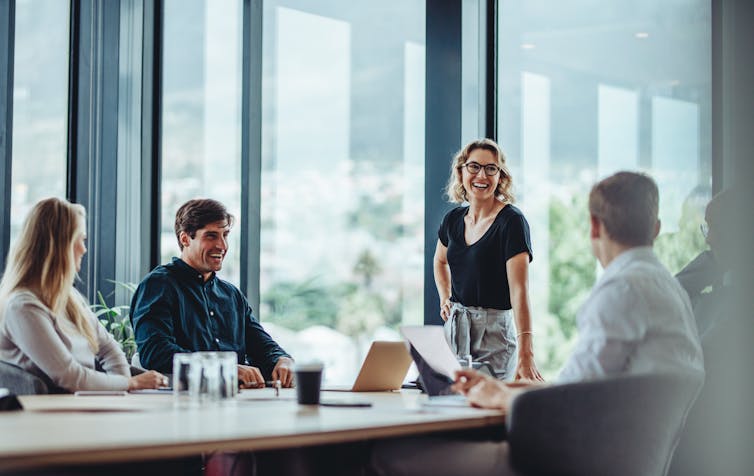 Four people working around a table in an office.